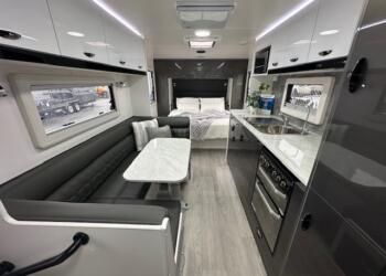 Dining area, kitchen and bed in 2023 Viscount V3.2 Club Lounge caravan