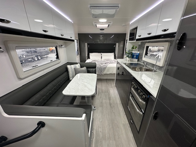 Dining area, kitchen and bed in 2023 Viscount V3.2 Club Lounge caravan