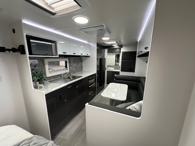 Kitchen and dining area in 2023 Viscount V3.2 Club Lounge caravan