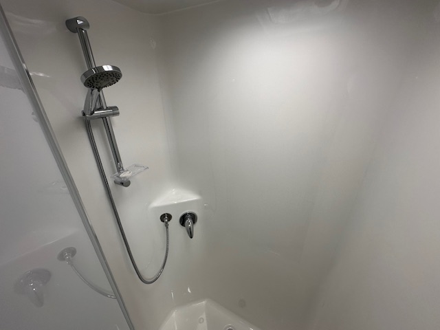 Showerhead and bathroom in the 2024 Viscount V1 caravan