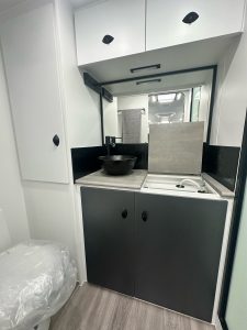 20’ Highclere Chateau Tandem exterior side with entrance|20’ Highclere Chateau Tandem specification label|20’ Highclere Chateau Tandem cupboards|20’ Highclere Chateau Tandem bathroom washing machine|20’ Highclere Chateau Tandem kitchen pantry|20’ Highclere Chateau Tandem sitting area|20’ Highclere Chateau Tandem suspension|20’ Highclere Chateau Tandem exterior front with gas tanks|20’ Highclere Chateau Tandem exterior plugs|20’ Highclere Chateau Tandem kitchen